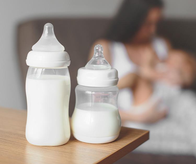 Baby bottles filled with milk on a table