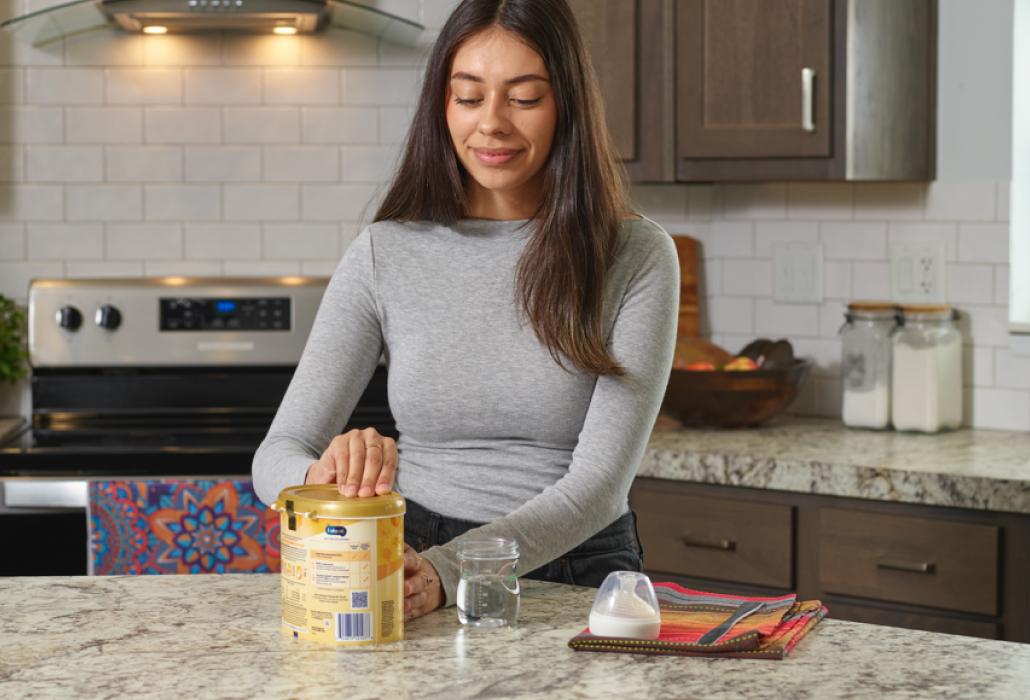 Mom preparing to make a bottle of formula