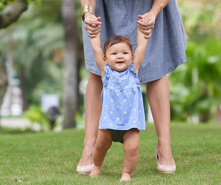 Mom teaching his child how to walk