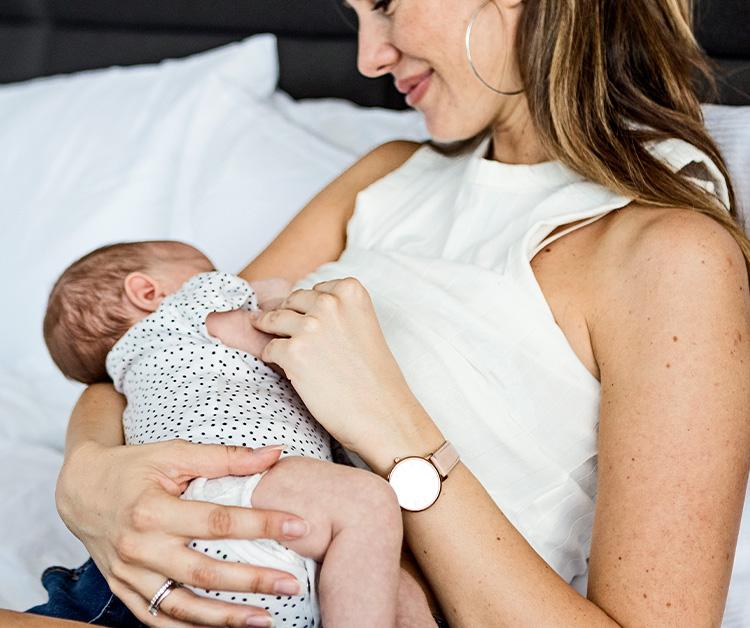 Mom holding her little baby girl