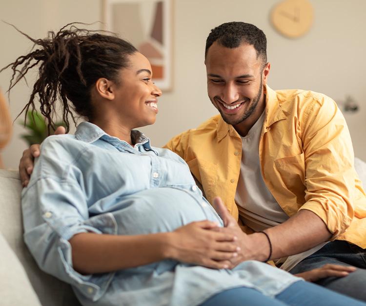 Expecting couple talking in baby's nursery