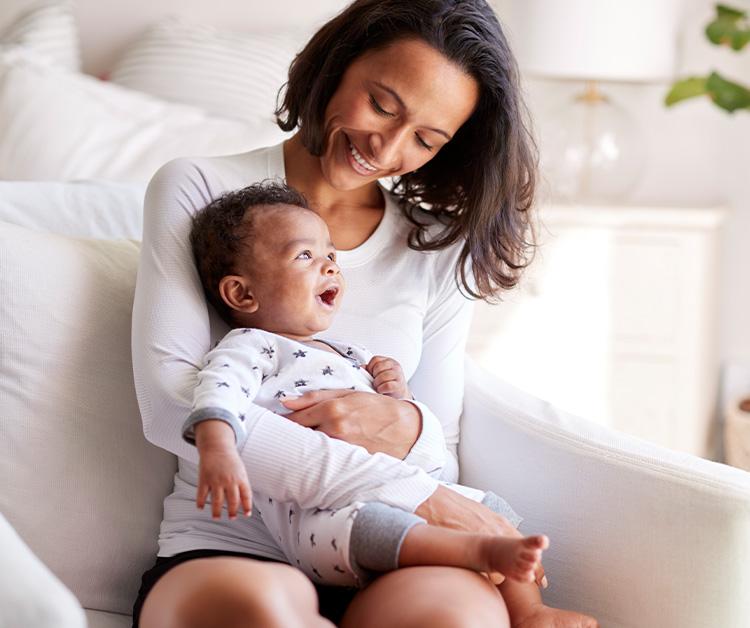 Mom holding her smiling baby