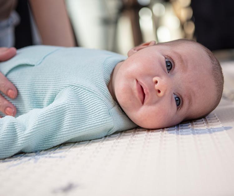 Baby laying on a blanket