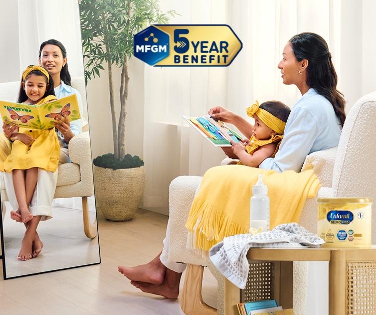 Baby being held by her mom sitting in a chair looking at a book, with Enfamil® NeuroPro™ Infant Formula that has MFGM 5 year benefit