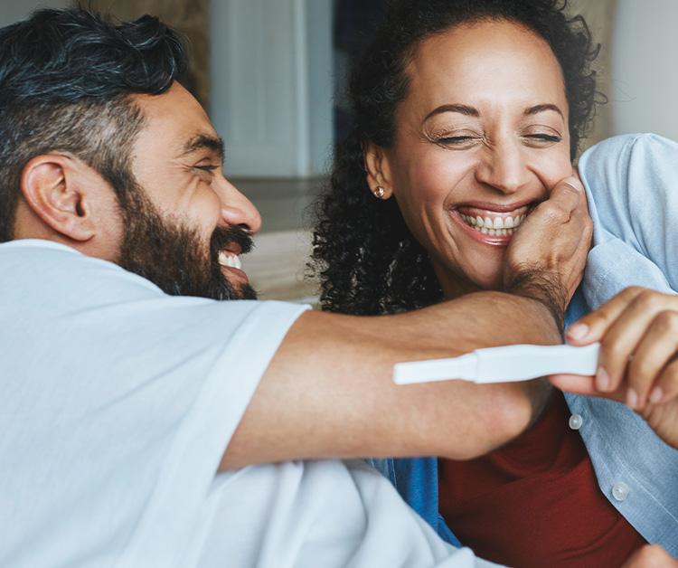Happy couple looking at a pregnancy test