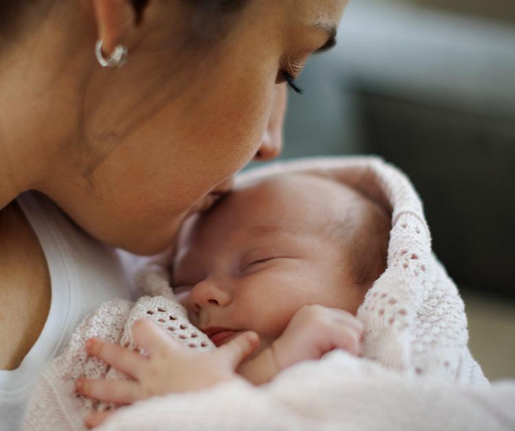 Mom kissing her baby