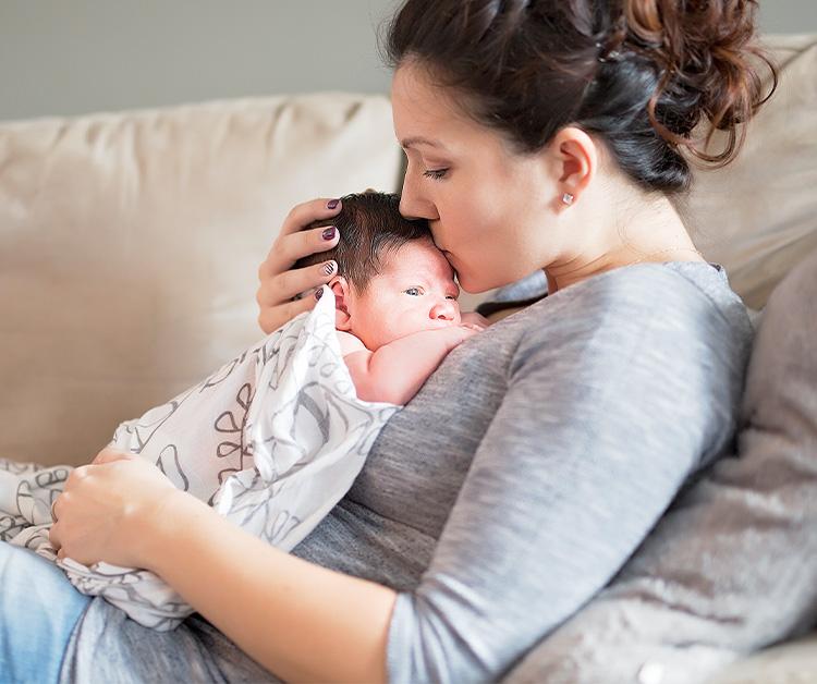 Pregnant mom sitting cross-legged holding her belly