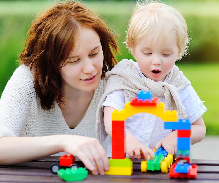 Toddler and his mom playing with blocks